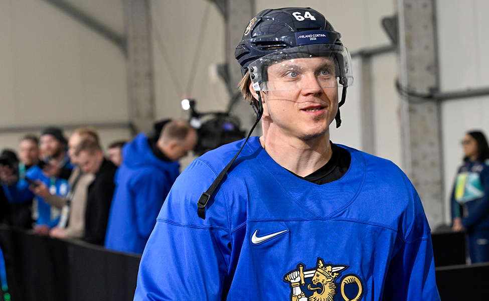 En manlig ishockeyspelare med hjälm på huvudet. Han är klädd i Finlands landslags speldräkt.